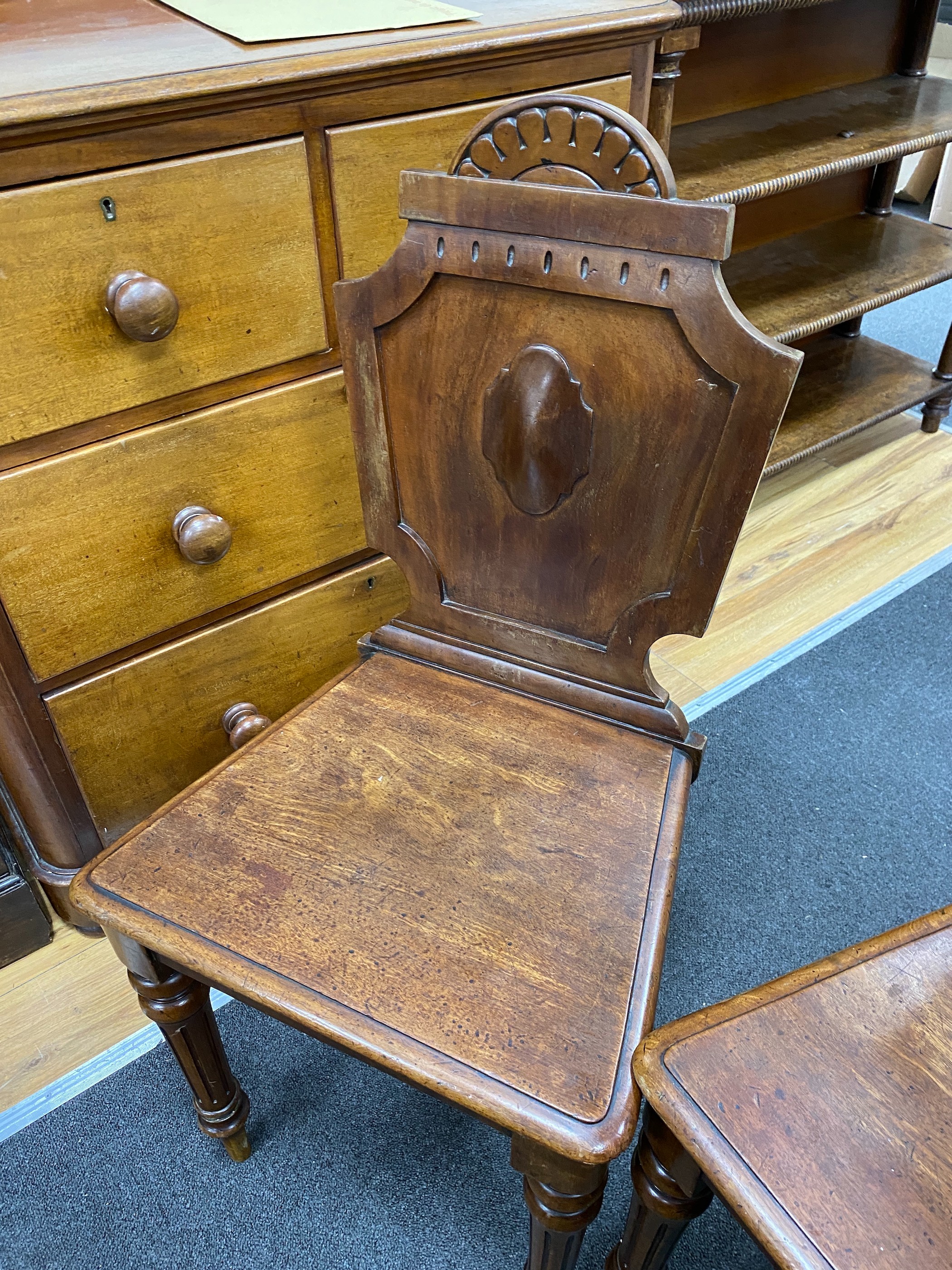 A pair of Victorian mahogany hall chairs